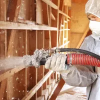 A technician performing an insulation service